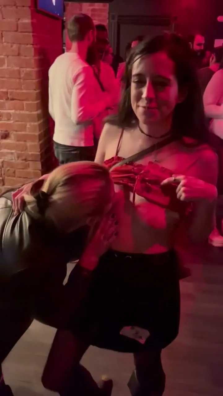 Horny Girl Starts Sucking Her Friend’s Tits Right in Front of the Club Like It’s No Big Deal