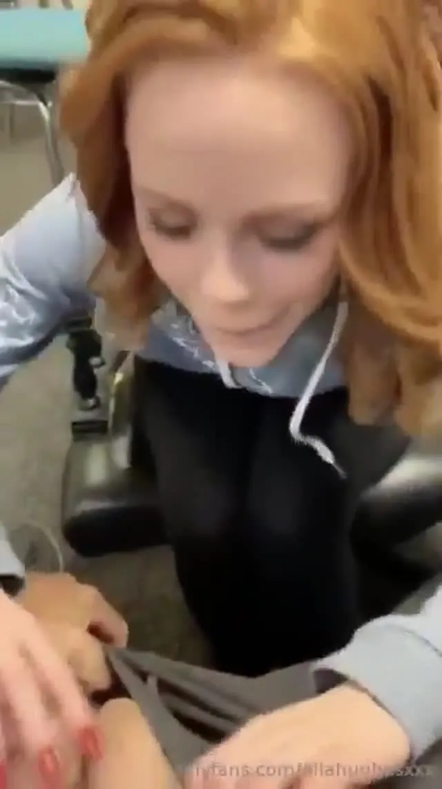 slim girl blowing in busy room with people around